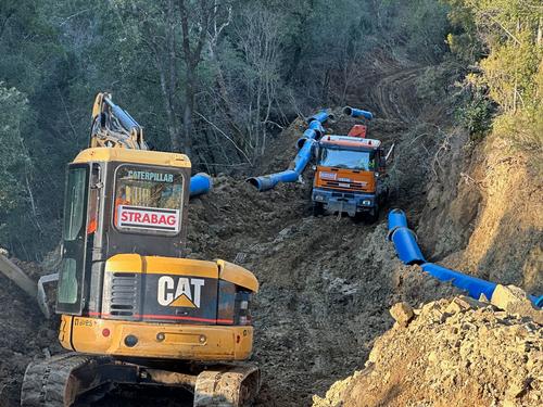 Excavator during construction work on the Himara Water Extraction Project on the Shushica River