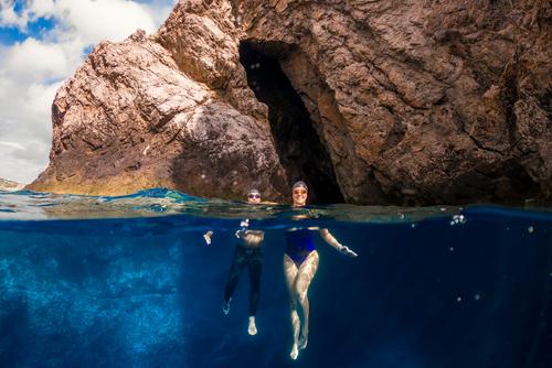 Dina Levačić and Darko Hren in front of a seal cave Open water swimmers in front of seal cave in the Adriatic Sea