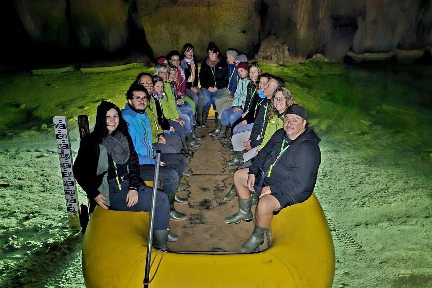 Staff in a rubber boat in a water cave