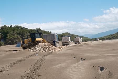 Bulldozer and lorries on the beach at Narta lagoon, Albania, May 2026