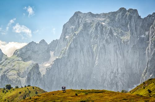 People in front of mountains