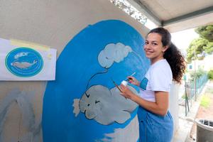 artist with mural