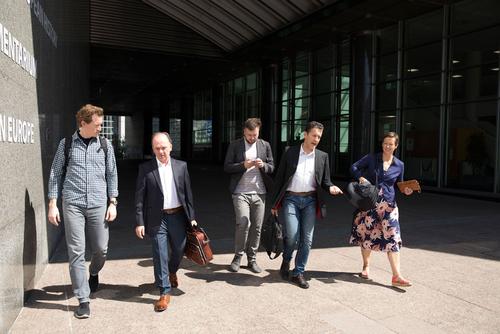 Ryan Gellert (Patagonia), Trifon Murataj (resident of Kutë), Igor Vejnovic (Bankwatch), Gabriel Schwaderer (EuroNatur), Mihela Hladin Wolfe (Patagonia) leaving the building