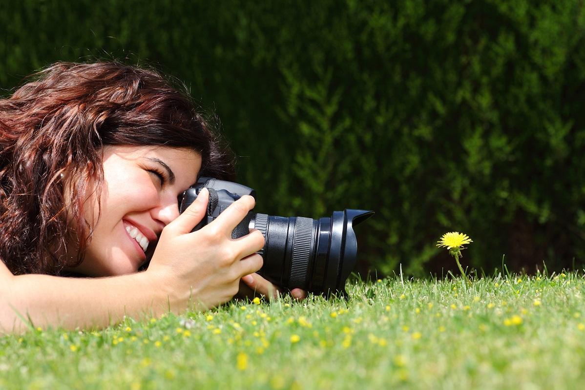 Woman photographing dandelions