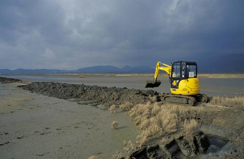 Digger in Ulcinj Salina repairing dams