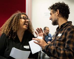Two people are talking and laughing.