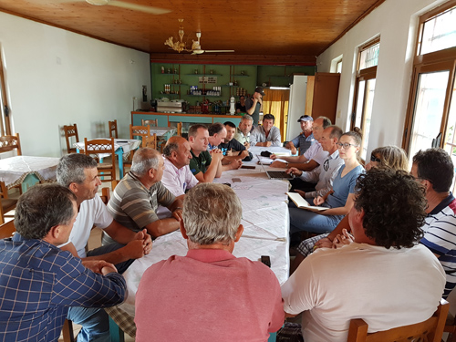 Residents of the village of Kut sitting at a long table