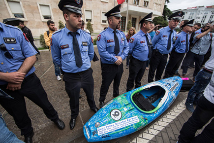 Six policemen guarding a kayak