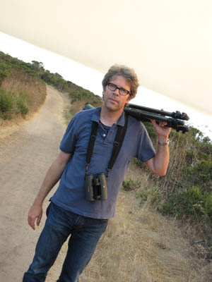 Jonathan Franzen with tripod and binoculars
